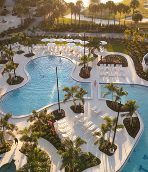 Aerial view of Saddlebrook Resort's Super Pool, featuring palm-lined waterways, shaded loungers, and a serene Florida setting